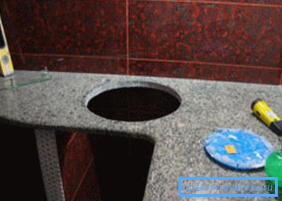 Nișă sub chiuveta rotundă în bucătărie.